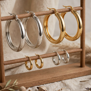 Illustrative styling image of gold and silver plated hoop earrings on a display stand