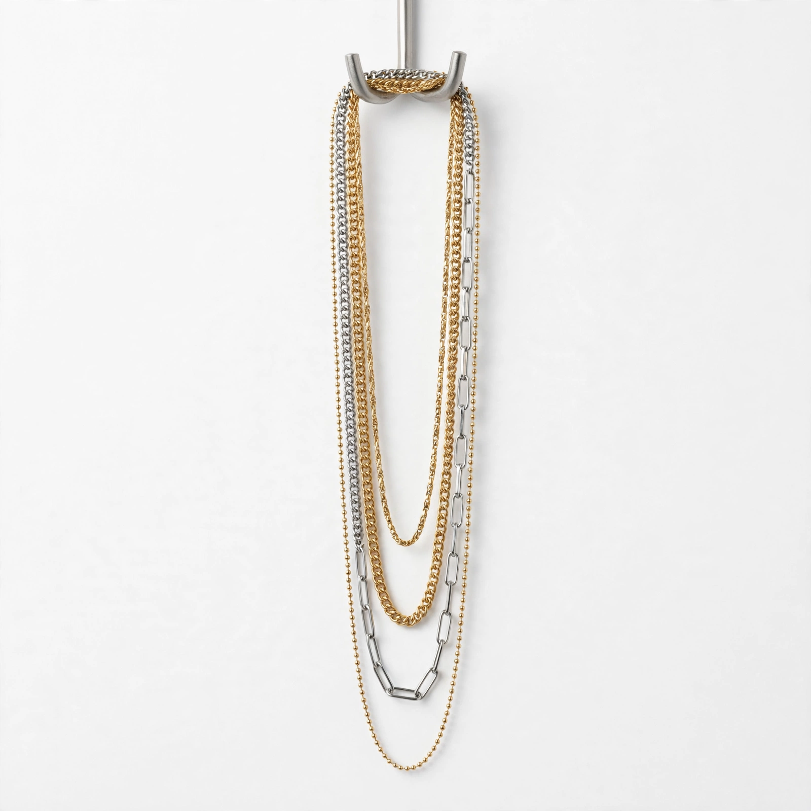 Illustrative styling image of layered chain necklaces