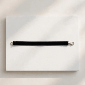 Illustrative styling image of a black choker necklace